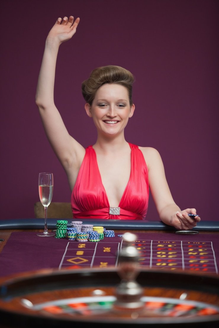 Roulette wheel in professional live studio with dealer hands visible